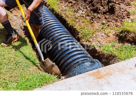 In course of construction, drainage black pipe is installed in trench 118535676