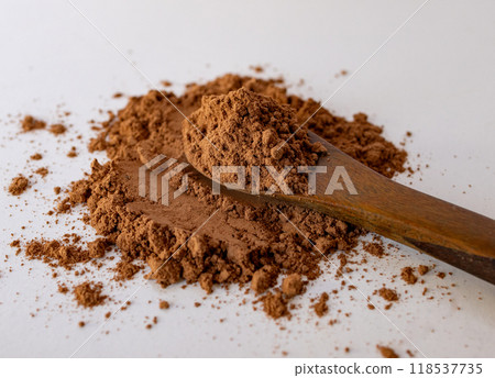 Textured natural cocoa powder .Close-up photo on wooden spoon. Textured natural cocoa powder .Close-up photo on wooden spoon. 118537735