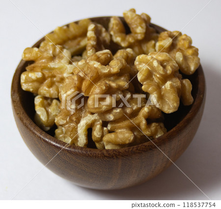 Walnuts in bowl isolated on white background. Healthy food concept. 118537754