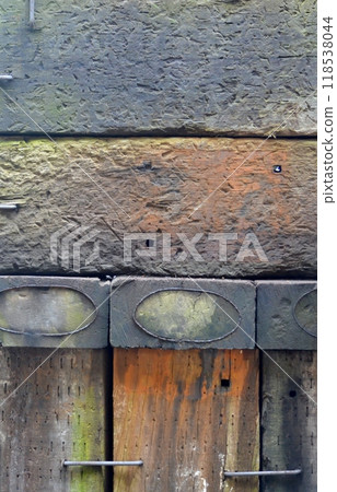 A fence made from recycled old sleepers and joined with braces A fence made from recycled old sleepers and joined with braces 118538044