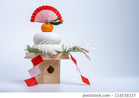 A photo of "Kagami mochi" placed on the left, white background, with a sanpo (pedestal) 118538337