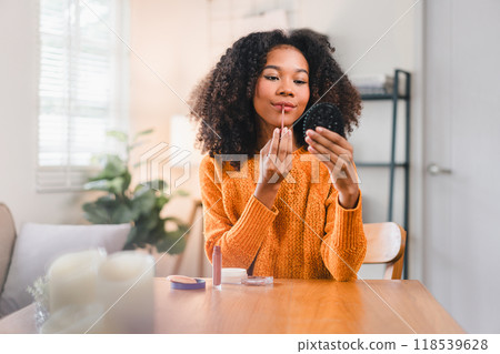 Happy African American Woman Applying Makeup at Home. 118539628