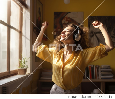 In the comfort of her modern home, a stylish woman immerses herself in the joy of music, donning headphones as she gracefully dances, creating a dynamic and expressive atmosphere within her domestic 118542414