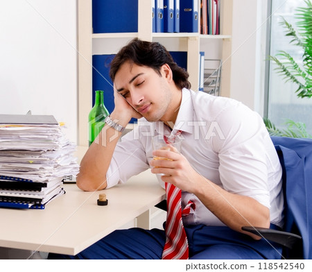 Young businessman employee drinking in the office Young businessman employee drinking in the office 118542540