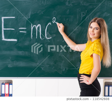 Young female student in front of the chalkboard Young female student in front of the chalkboard 118542608