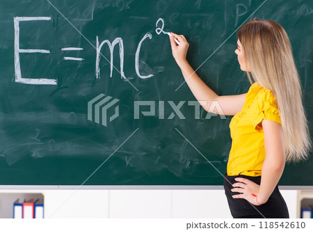 Young female student in front of the chalkboard 118542610