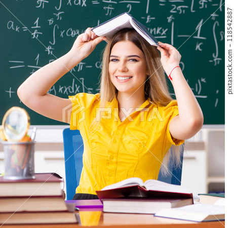 Young female student in front of the chalkboard 118542887