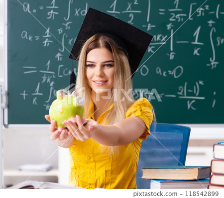 Young female student in front of the chalkboard Young female student in front of the chalkboard 118542899