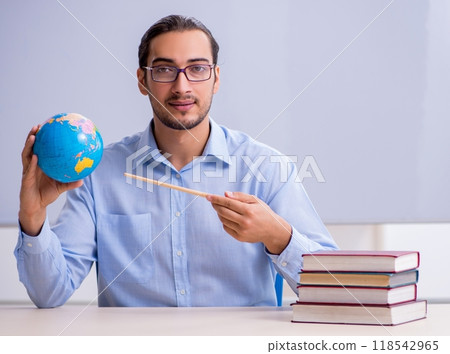 Young male geography teacher in front of whiteboard 118542965