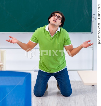 Young male student in front of green board Young male student in front of green board 118542971
