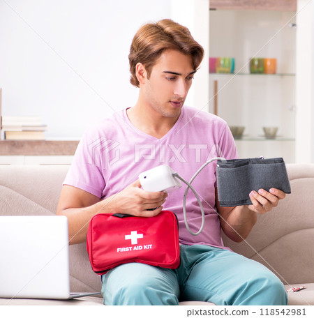 Sick man at home with first aid kit 118542981