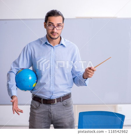 Young male geography teacher in front of whiteboard 118542982