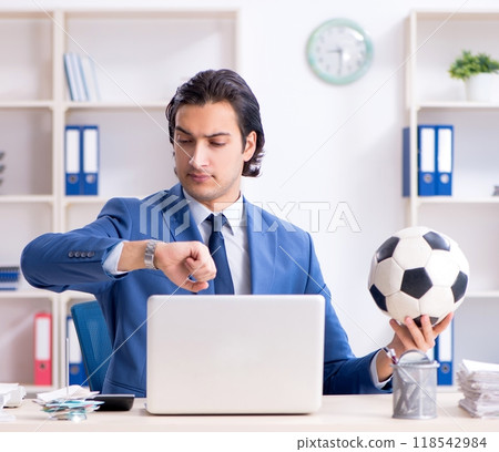 Young handsome businessman with soccer ball in the office Young handsome businessman with soccer ball in the office 118542984