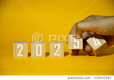 Text flip block 2024 to 2025 by hand, resolution, strategy, plan, goal, motivation, reboot, business and new year holiday concept. 118543562