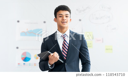 Smiling foreign businessman holding a tablet 118543710