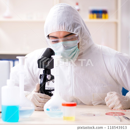 Young handsome chemist working in the lab Young handsome chemist working in the lab 118543913