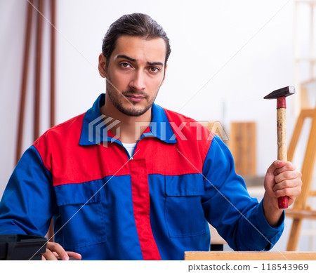 Young male contractor working in workshop Young male contractor working in workshop 118543969