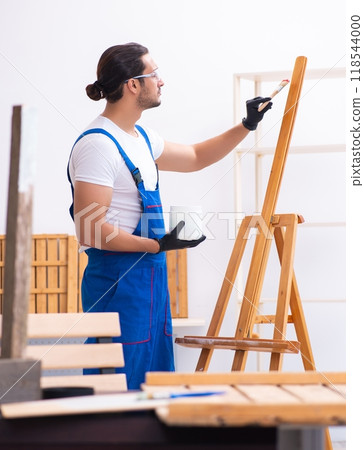 Young male contractor working in workshop 118544000