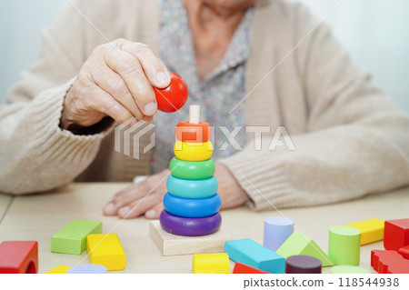 Asian elderly woman playing game. 118544938