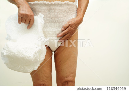 Asian senior woman patient wearing adult incontinence diaper pad in hospital. 118544939
