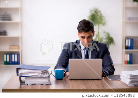 Young male employee working in the office 118545098