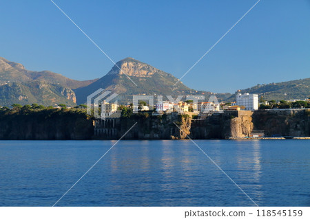 Sorrento, Naples, Campania, Republic of Italy, Southern Europe: Cliffside townscape seen from the ferry 118545159