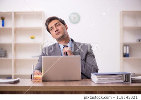 Young male employee working in the office Young male employee working in the office 118545321