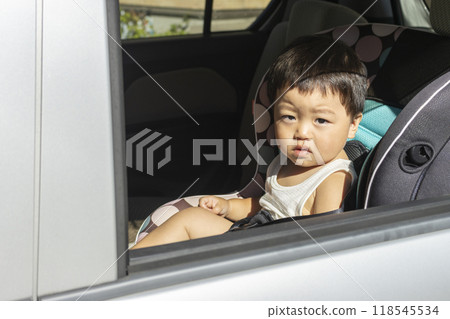Baby sitting in a child seat (boy, 1 year old, Japanese) 118545534