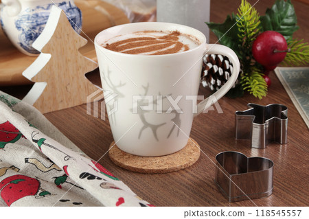 Ceramic cappuccino cup and table decor. Christmas festivities. Background for design. Ceramic cappuccino cup and table decor. Christmas festivities. Background for design. 118545557