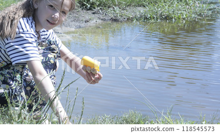 Schoolgirl on vacation run handmade boat on lake. Summer lifestyle. Rest and leisure.  118545573