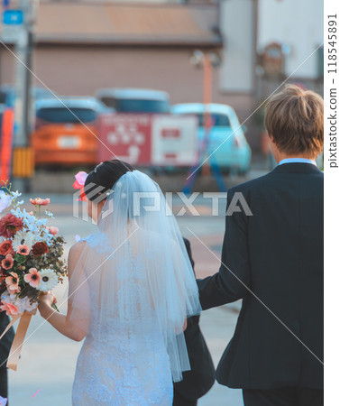 Bride and groom receiving congratulations from guests 118545891