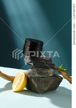 Mock up for cosmetic advertising with an unbranded cosmetic pot in black, which placed on a stack of stone podiums, decorated with dry tree branches, against on blue background Mock up for cosmetic advertising with an unbranded cosmetic pot in black, which placed on a stack of stone podiums, decorated with dry tree branches, against on blue background 118546567
