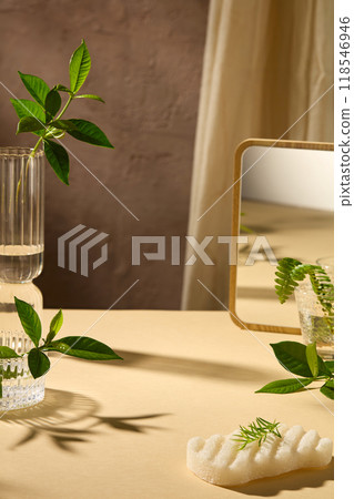 Template photo to design advertising poster with spa theme in light yellow color tone. Blank space in the center of table for product displaying, glass, green plants, a soap and a mirror placed around Template photo to design advertising poster with spa theme in light yellow color tone. Blank space in the center of table for product displaying, glass, green plants, a soap and a mirror placed around 118546946