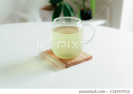 Green tea on a stylish coaster Green tea on a stylish coaster 118547032