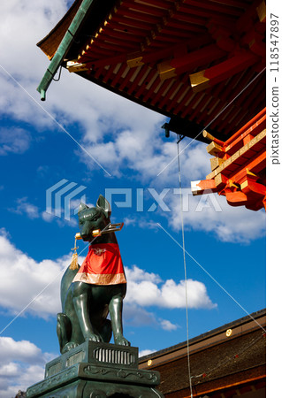 Fox god statue against blue sky at Fushimi Inari Taisha in Autumn season, Kyoto, Japan. 118547897