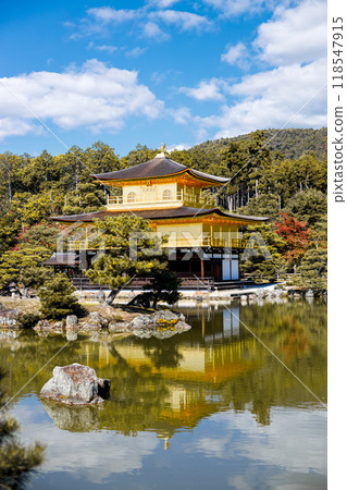 Golden pavilion of the Kinkakuji temple surrounded with Japanese garden and pond in Autumn season. Kyoto, Japan. 118547915