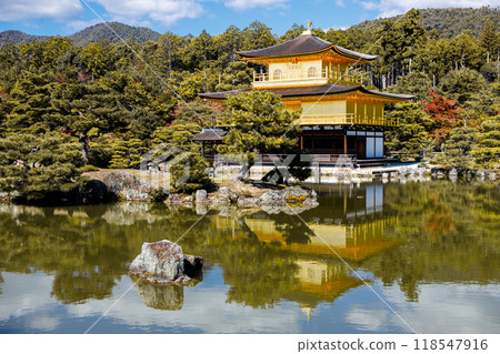 Golden pavilion of the Kinkakuji temple surrounded with Japanese garden and pond in Autumn season. Kyoto, Japan. 118547916