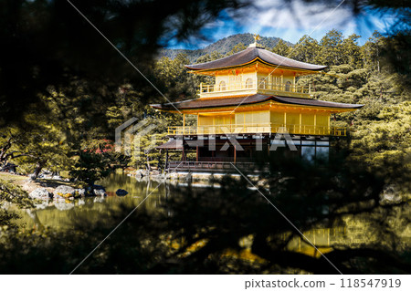 Golden pavilion of the Kinkakuji temple surrounded with Japanese garden and pond in Autumn season. Kyoto, Japan. Golden pavilion of the Kinkakuji temple surrounded with Japanese garden and pond in Autumn season. Kyoto, Japan. 118547919