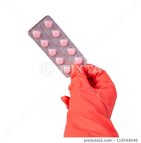 Pink pills medical in rubber glove hand isolated on the white 118548646