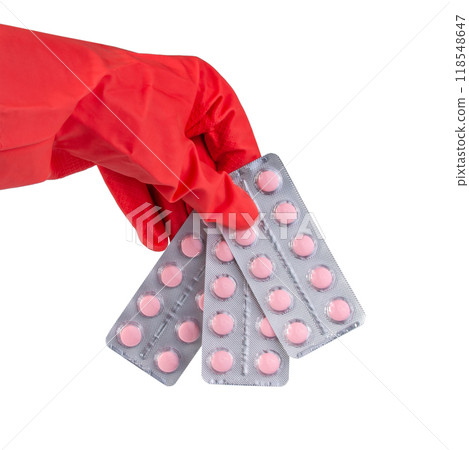 Pink pills medical in rubber glove hand isolated on the white 118548647