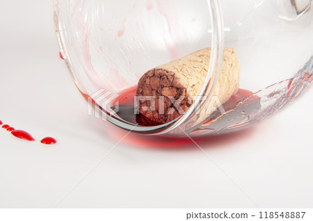 Wine cork in wine glass on white background Wine cork in wine glass on white background 118548887