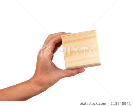 Wooden square cube in hand isolated on the white Wooden square cube in hand isolated on the white 118548941