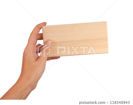 Wooden brick block in hand isolated on the white Wooden brick block in hand isolated on the white 118548943