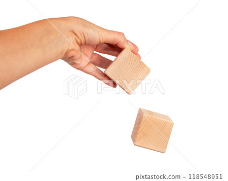 Wooden square cube in hand isolated on the white Wooden square cube in hand isolated on the white 118548951