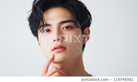 A beauty portrait of a young and cool Japanese man touching his chin with his fingers 118548981