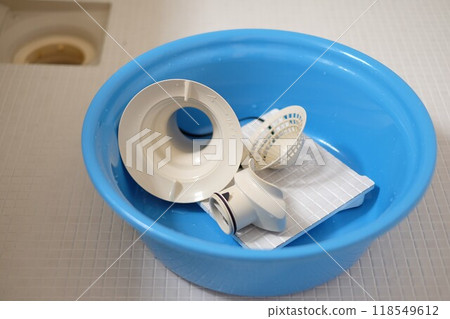Cleaning the bathtub drain Cleaning the bathtub drain 118549612