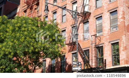 New York City building architecture, Manhattan. Residential house exterior. Red brick, fire escape. 118549896