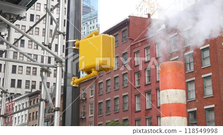 Steam vapor vented, New York City street steam system, orange vapour tube stack. Hot smoke from pipe Steam vapor vented, New York City street steam system, orange vapour tube stack. Hot smoke from pipe 118549998