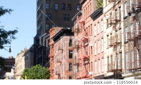 New York City building architecture, Manhattan. Residential house exterior. Red brick, fire escape. 118550014