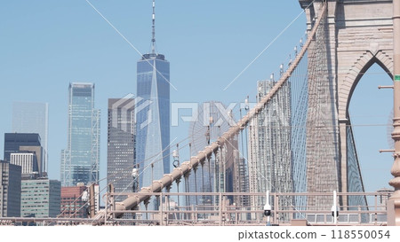 Brooklyn Bridge cables, Manhattan downtown. New York City skyline, financial district cityscape. 118550054